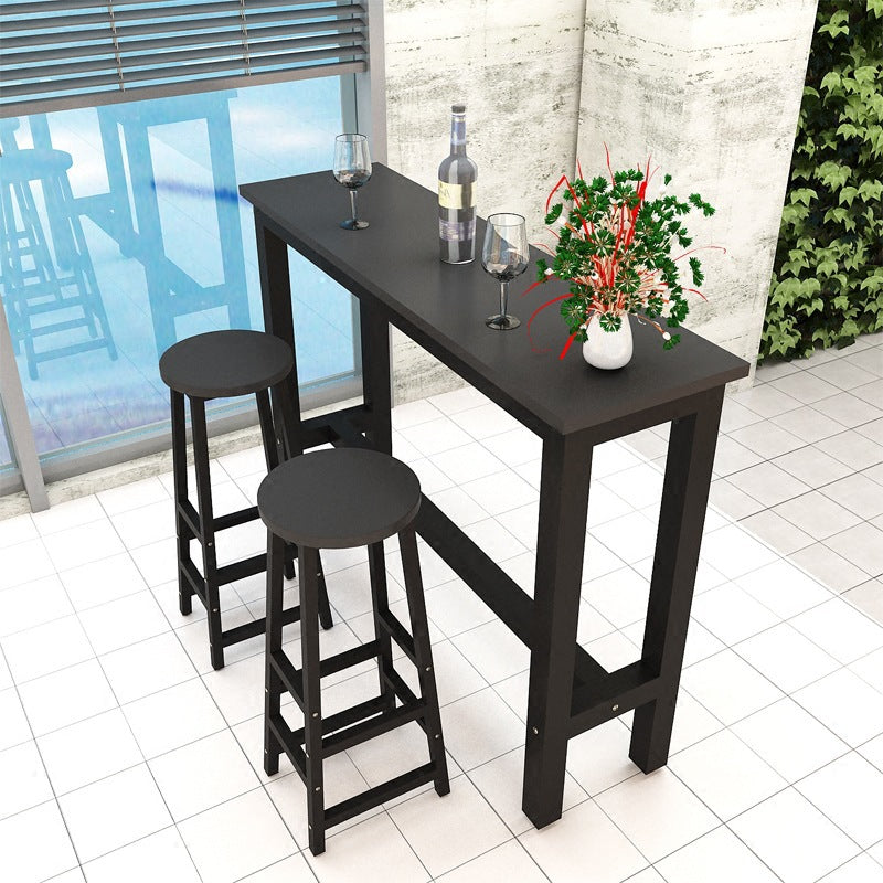 Black bar stool next to a black bar table