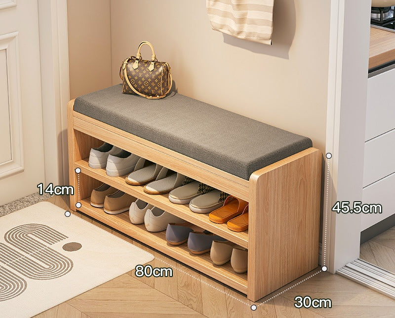 Wooden shoe bench with cushioned seat and shoe storage compartments, measurements indicated.