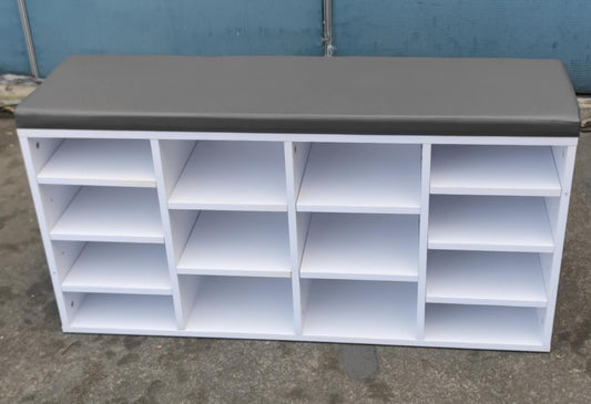 White shelving unit with a gray top against a blue wall.