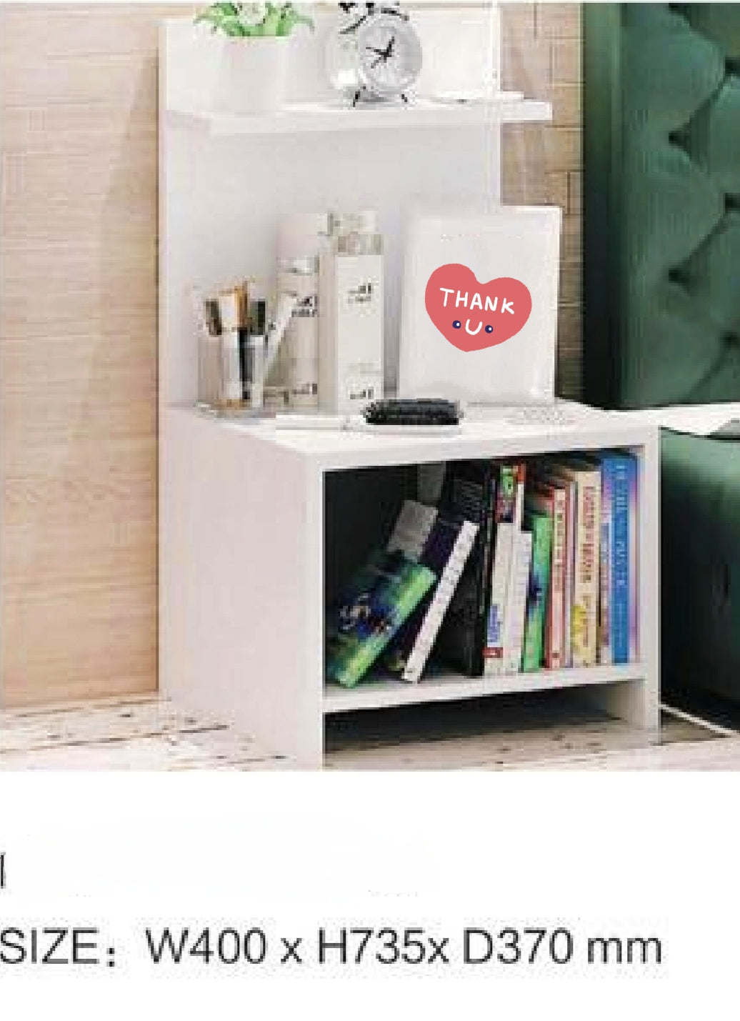 A white bedside table with a shelf and a side rack, placed against a wooden wall in a room with books and a clock on it. The table has a 'THANK YOU' note on top.