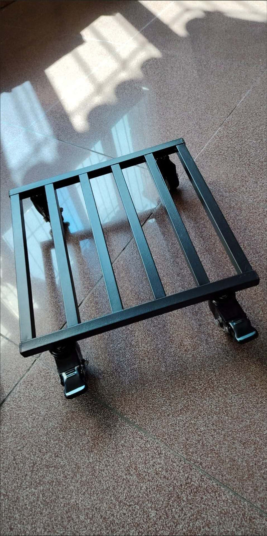 A black metal frame pot trolley with wheels, viewed from a low angle against a indoor background.