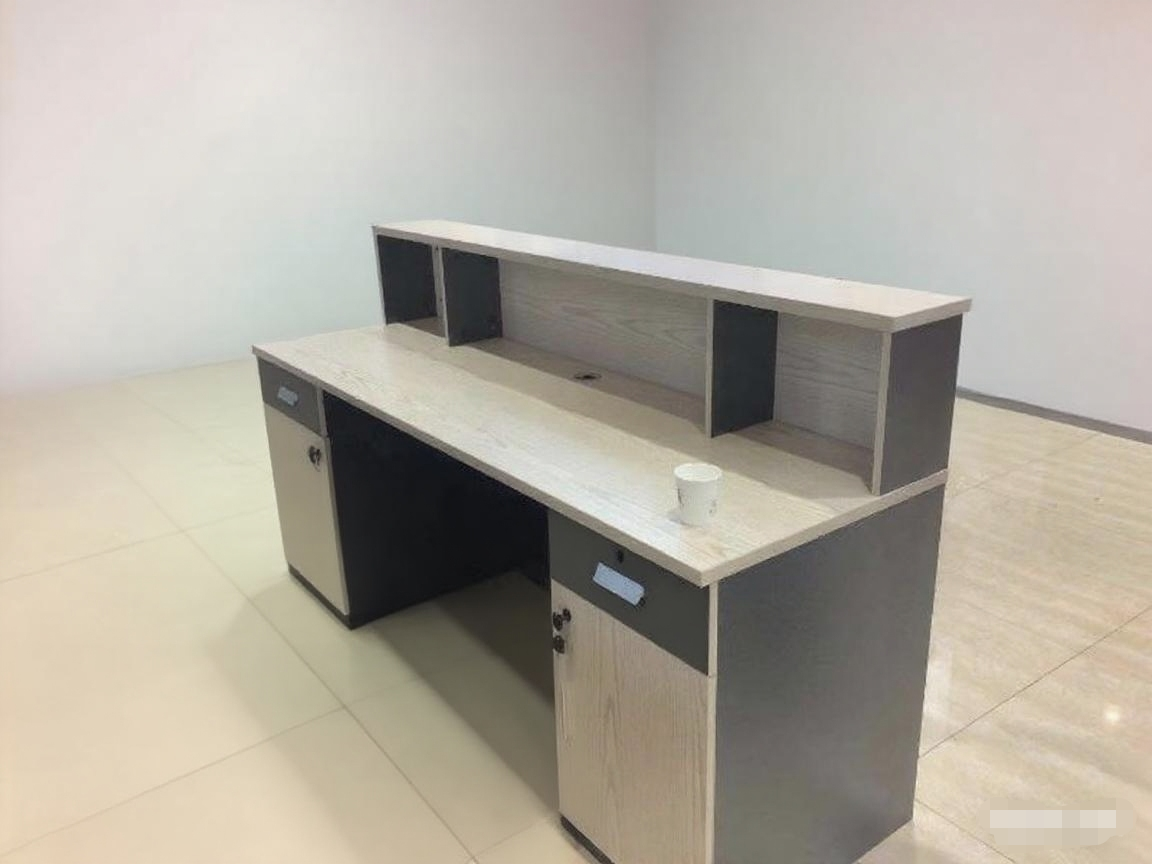 Modern office desk with a white top and gray sides on a tiled floor.