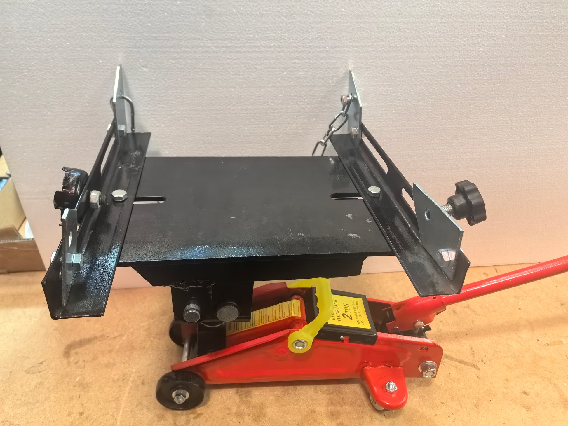 Transmission cradle on a wooden floor with a neutral background